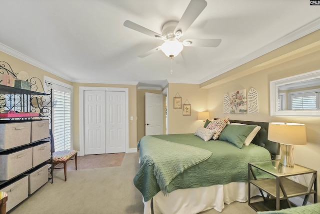 carpeted bedroom with ornamental molding, a closet, and ceiling fan