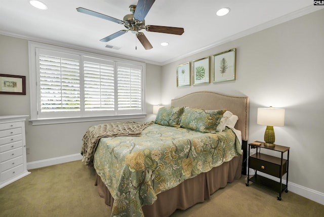 carpeted bedroom with ornamental molding and ceiling fan