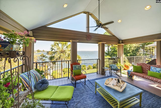 sunroom featuring a water view, ceiling fan, and vaulted ceiling