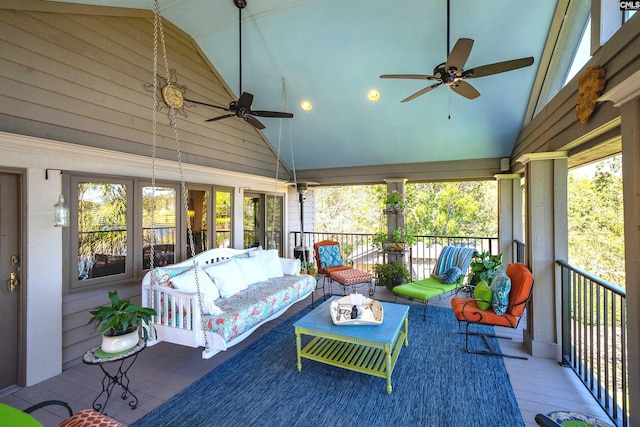 sunroom / solarium with lofted ceiling, a wealth of natural light, and ceiling fan