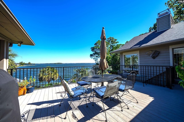 deck with a grill and a water view