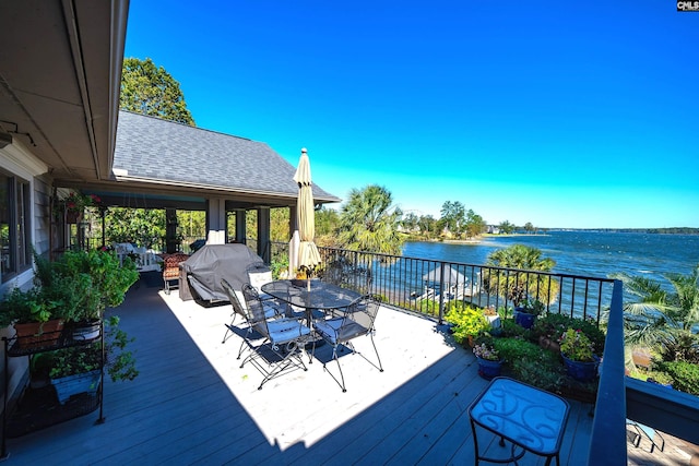 deck with a water view and grilling area