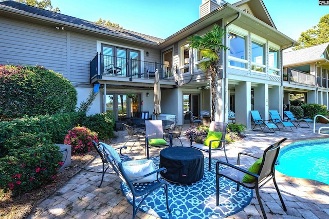 back of house with a patio and a balcony