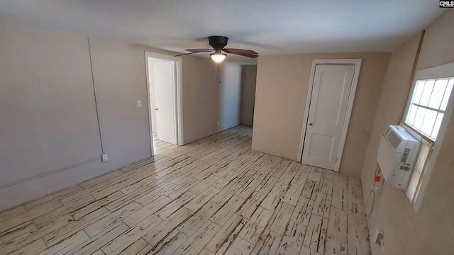 empty room with a wall mounted AC and ceiling fan