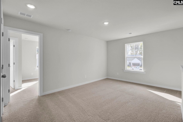 unfurnished room featuring light colored carpet