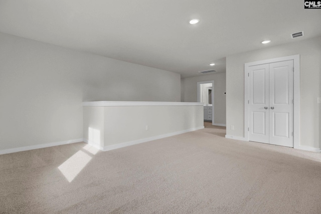 empty room with light colored carpet