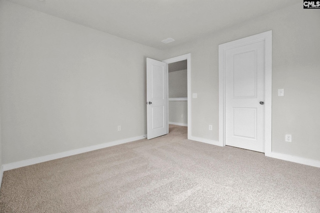 unfurnished bedroom featuring light carpet