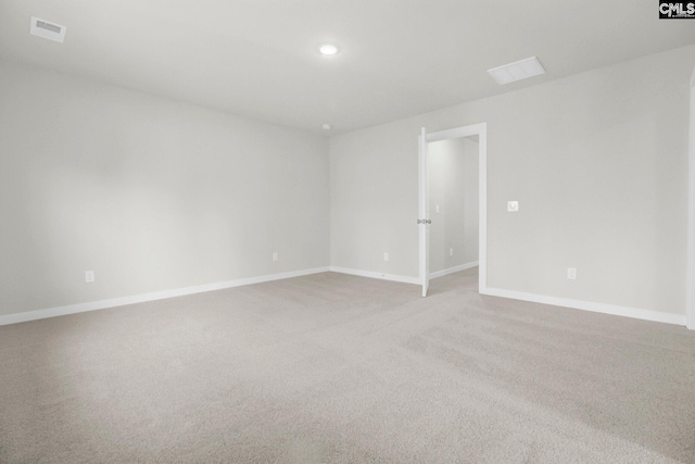 unfurnished room featuring light carpet