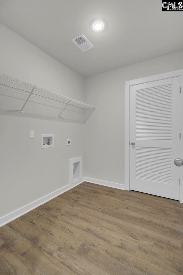 laundry room featuring hookup for a washing machine, electric dryer hookup, and hardwood / wood-style floors