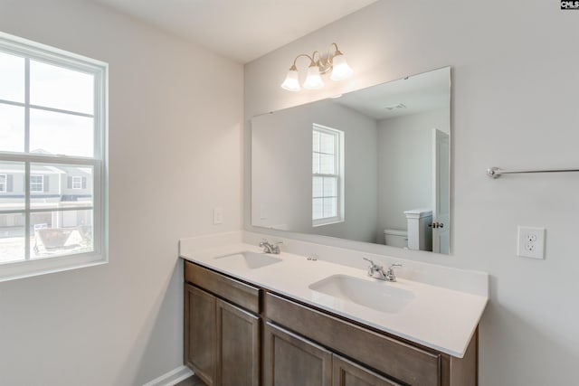 bathroom featuring vanity and toilet