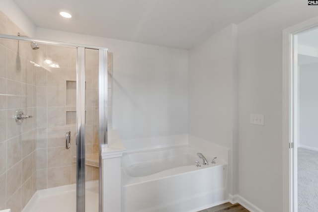 bathroom with separate shower and tub