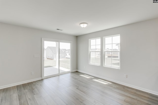 spare room featuring light wood-type flooring