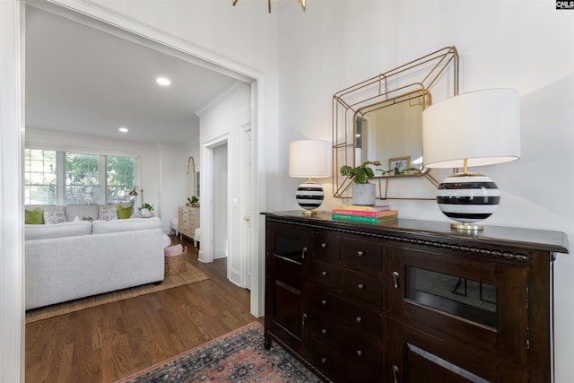 corridor featuring dark wood-type flooring and crown molding