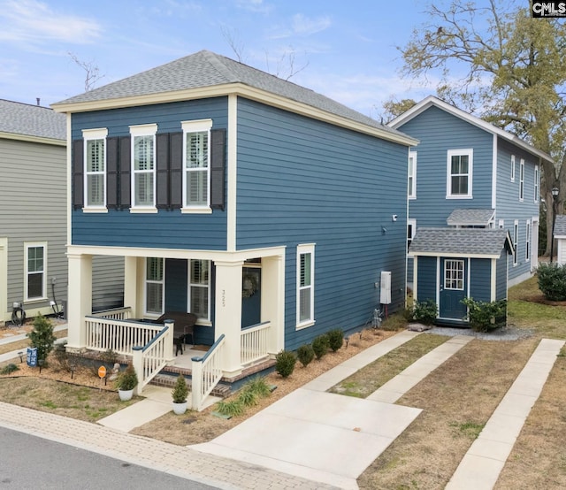 view of front of home with a storage shed and a porch