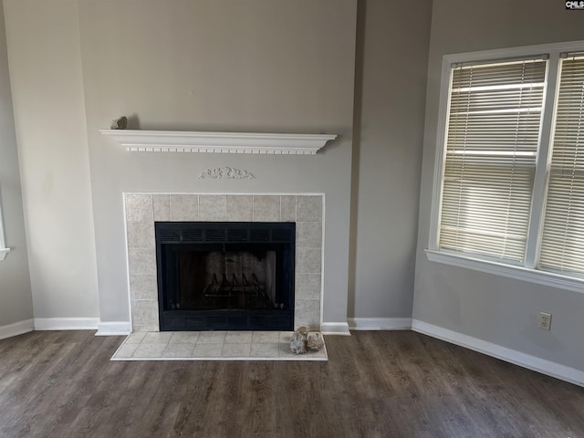 room details featuring wood-type flooring and a tile fireplace