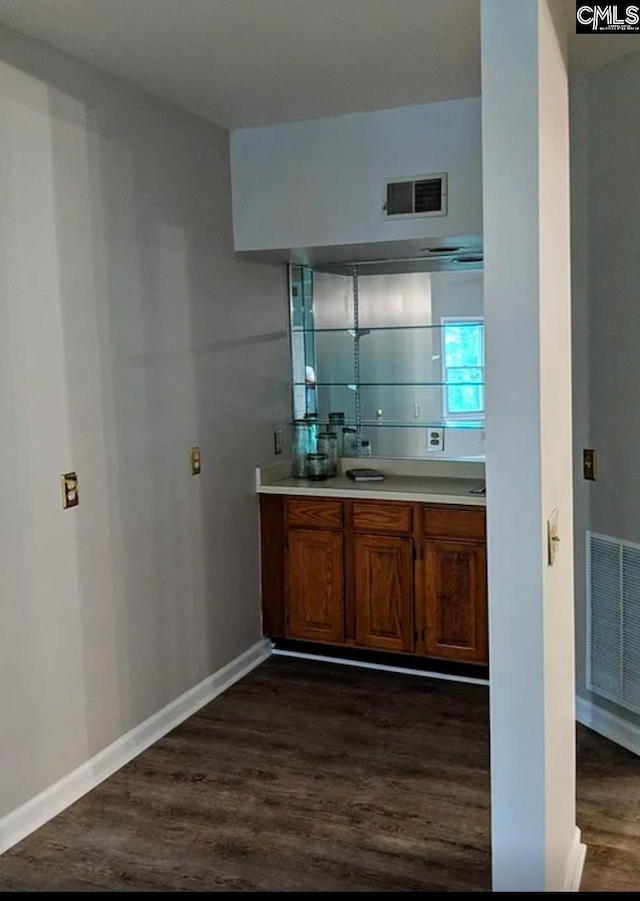 bar with dark wood-type flooring