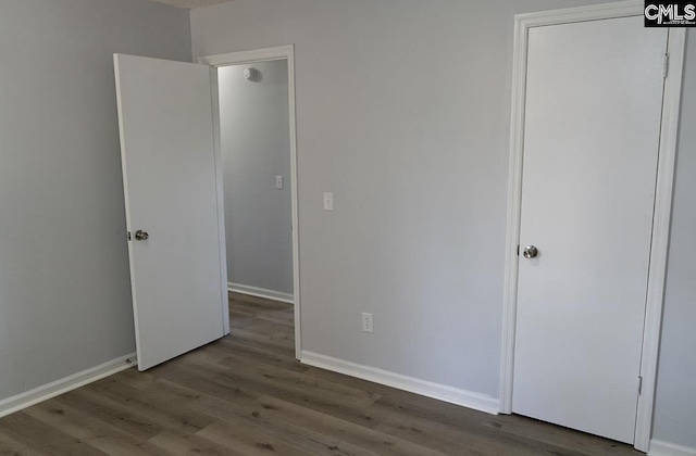 unfurnished bedroom with hardwood / wood-style floors