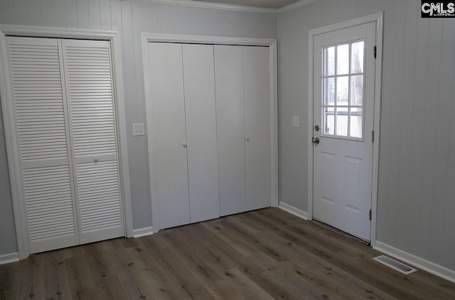 interior space featuring ornamental molding and light wood-type flooring