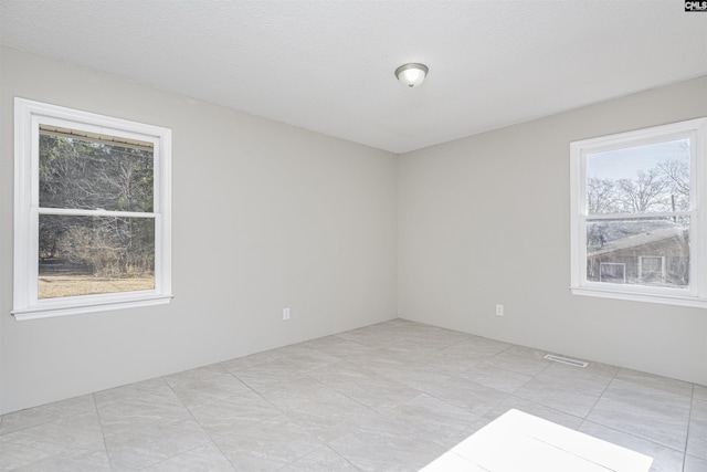 empty room featuring a textured ceiling