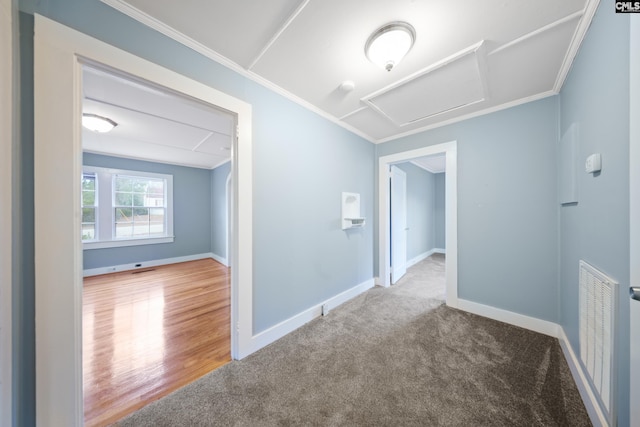 hall with ornamental molding and carpet floors