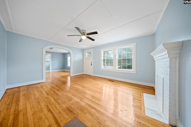 unfurnished living room featuring crown molding, plenty of natural light, ceiling fan, and light hardwood / wood-style flooring