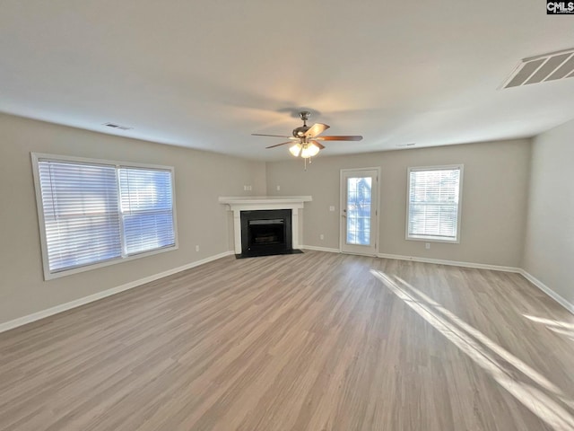 unfurnished living room with ceiling fan and light hardwood / wood-style floors