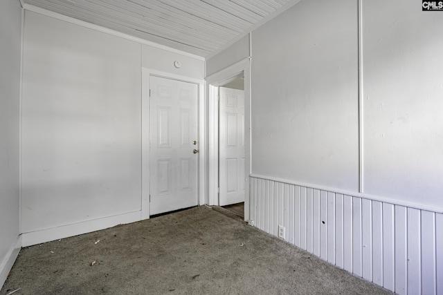 spare room with dark colored carpet