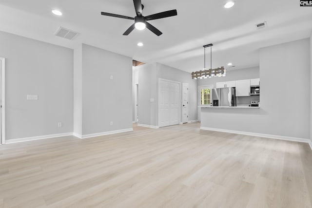 unfurnished living room with ceiling fan and light hardwood / wood-style floors