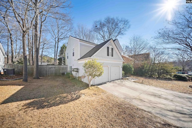 view of home's exterior with cooling unit and a garage