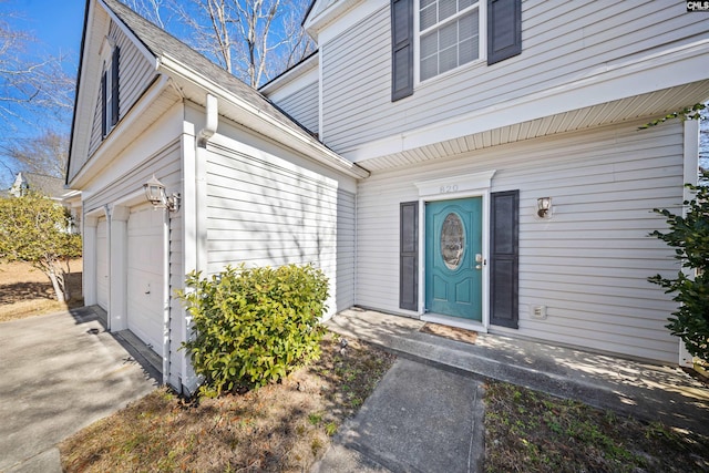 view of exterior entry with a garage