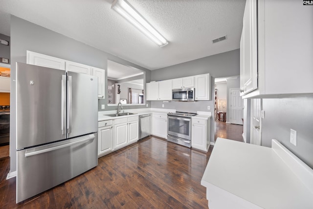 kitchen with white cabinetry, appliances with stainless steel finishes, sink, and a textured ceiling