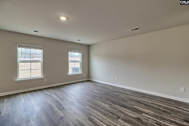 empty room with dark hardwood / wood-style flooring