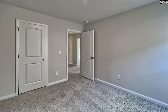 unfurnished bedroom featuring light carpet