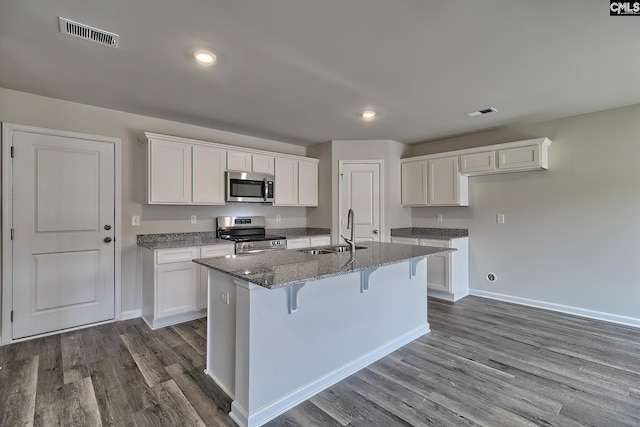 kitchen featuring white cabinetry, an island with sink, stainless steel appliances, and sink