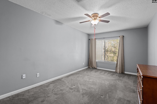 carpeted spare room featuring ceiling fan and a textured ceiling