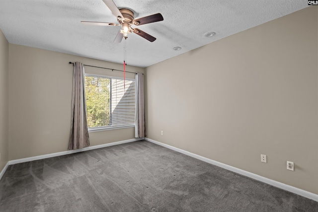 spare room featuring ceiling fan, carpet, and a textured ceiling