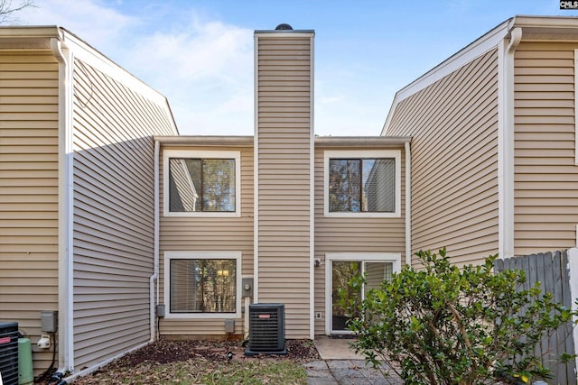 rear view of property featuring central AC unit