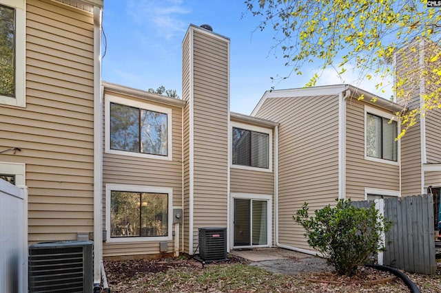 rear view of house featuring central AC unit