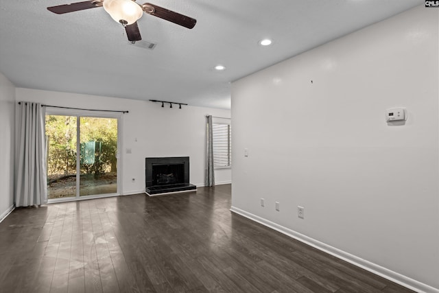 unfurnished living room featuring dark hardwood / wood-style floors and ceiling fan