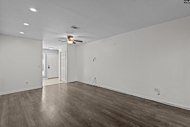 unfurnished room with a textured ceiling, dark hardwood / wood-style floors, and ceiling fan