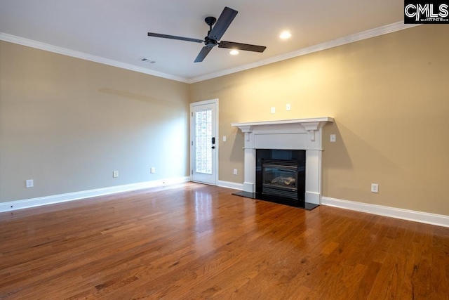 unfurnished living room featuring wood-type flooring, ornamental molding, and ceiling fan