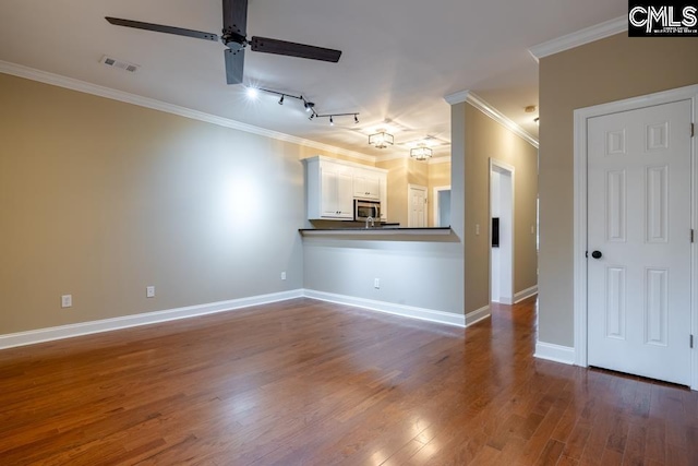 unfurnished living room with ceiling fan, track lighting, ornamental molding, and dark hardwood / wood-style flooring