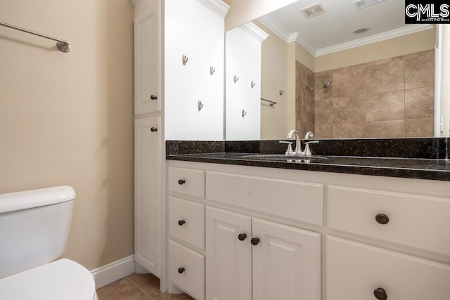 bathroom featuring tile patterned flooring, ornamental molding, vanity, and toilet