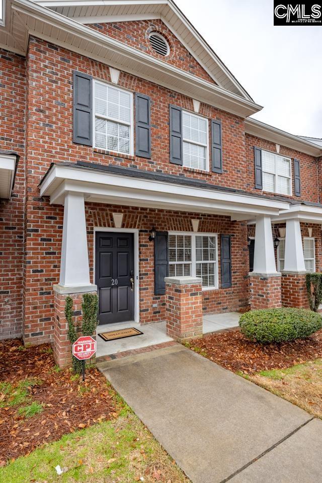 townhome / multi-family property featuring covered porch