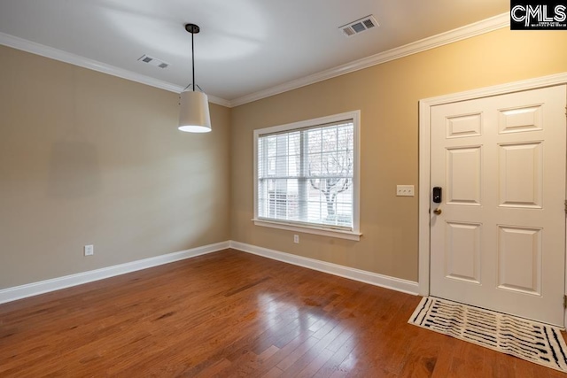 entrance foyer featuring crown molding and dark hardwood / wood-style floors