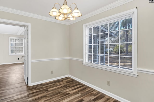 unfurnished dining area with an inviting chandelier, ornamental molding, and dark hardwood / wood-style flooring