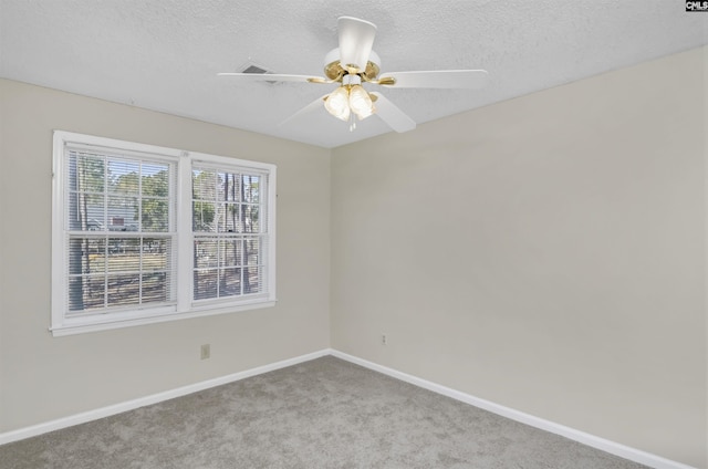 carpeted empty room with a textured ceiling and ceiling fan