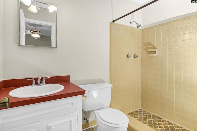 bathroom featuring vanity, tiled shower, and toilet