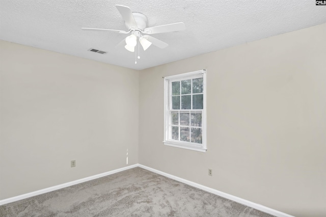 spare room with light carpet, a textured ceiling, and ceiling fan