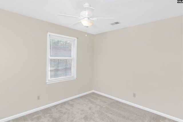 carpeted empty room featuring ceiling fan